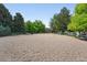 Spacious dog park area with mature shade trees, benches, and a fenced-in perimeter for secure off-leash enjoyment at 3300 W Florida Ave # 117, Denver, CO 80219