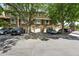 Charming townhome with brick facade, mature trees, garages, and convenient parking at 3300 W Florida Ave # 117, Denver, CO 80219