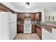 Bright kitchen featuring stainless steel appliances, wooden cabinets, and tiled floors at 3300 W Florida Ave # 117, Denver, CO 80219