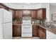 Charming kitchen featuring updated stainless steel appliances and wood cabinetry at 3300 W Florida Ave # 117, Denver, CO 80219
