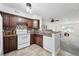 Well-lit kitchen with dark cabinets, neutral countertops, and a stylish backsplash at 3300 W Florida Ave # 117, Denver, CO 80219