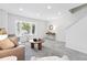 Bright and airy living room with plush carpet, modern furnishings, and a large bay window at 3300 W Florida Ave # 117, Denver, CO 80219