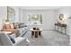 Bright living room features a cozy bay window, stylish decor, and comfortable seating at 3300 W Florida Ave # 117, Denver, CO 80219