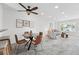 Open-concept living and dining room with large windows and modern decor at 3300 W Florida Ave # 117, Denver, CO 80219