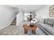 Bright living room with carpet, staircase, modern decor, and lots of natural light at 3300 W Florida Ave # 117, Denver, CO 80219