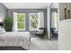 Comfortable main bedroom showcasing a sitting area and large windows at 3300 W Florida Ave # 117, Denver, CO 80219