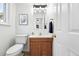 Charming powder room featuring a wood vanity and framed artwork at 3300 W Florida Ave # 117, Denver, CO 80219