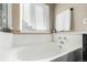 Clean bathroom with a bathtub and window at 8172 S York Ct, Centennial, CO 80122