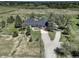 Aerial view of ranch style house showcasing long driveway and a well maintained yard at 1428 S County Road 23E, Berthoud, CO 80513