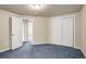 The carpeted basement is unfinished and includes closet and access to other rooms at 1428 S County Road 23E, Berthoud, CO 80513