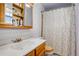 Traditional bathroom with a vanity cabinet and patterned shower curtain at 1428 S County Road 23E, Berthoud, CO 80513
