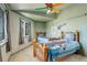 This ' bedroom offers two wood beds with brightly colored linens and a ceiling fan at 1428 S County Road 23E, Berthoud, CO 80513