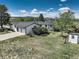 Exterior view of home showing a three car garage, large lawn and backyard playground at 1428 S County Road 23E, Berthoud, CO 80513