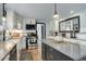 Stylish kitchen features white cabinets, stainless steel appliances, a center island, and hardwood floors at 1428 S County Road 23E, Berthoud, CO 80513