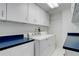This laundry room features a washer and dryer and ample storage cabinets above at 1428 S County Road 23E, Berthoud, CO 80513