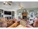 Open living room with a fireplace, TV, ceiling fans, and ample seating for entertaining guests at 1428 S County Road 23E, Berthoud, CO 80513