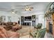 Spacious living room with a cozy fireplace, ceiling fans, and large entertainment center at 1428 S County Road 23E, Berthoud, CO 80513