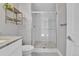Bathroom with a glass-enclosed shower featuring white subway tiles, gray grout, and hexagon floor tiles at 1270 Winona Ct, Denver, CO 80204