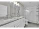 Luxurious bathroom with double vanity, granite countertops, and a glass-enclosed shower with subway tile at 1270 Winona Ct, Denver, CO 80204