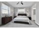 Bedroom featuring a large window, ceiling fan, neutral decor, and an ensuite bathroom at 1270 Winona Ct, Denver, CO 80204