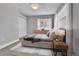 Comfortable bedroom with a queen size bed, carpet, and a window bringing in natural light at 1270 Winona Ct, Denver, CO 80204