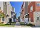 Modern townhouses featuring colorful exteriors, stone accents, and well-maintained lawns at 1270 Winona Ct, Denver, CO 80204