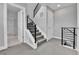 Hallway view with modern railing, access to a bathroom, and a staircase leading to the upper floors at 1270 Winona Ct, Denver, CO 80204
