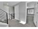 Bright hallway featuring modern black railing, leading to bedrooms with neutral carpeting and ample natural light at 1270 Winona Ct, Denver, CO 80204