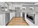 Modern kitchen with stainless steel appliances, white cabinets, granite countertops, and wood flooring at 1270 Winona Ct, Denver, CO 80204