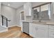 Modern kitchen with stainless steel appliances, white cabinets, and hardwood floors at 1270 Winona Ct, Denver, CO 80204