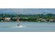 Scenic lake view featuring a motorboat on the water and a cityscape in the background at 1270 Winona Ct, Denver, CO 80204