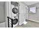 Convenient laundry area featuring a stacked washer and dryer, optimizing space and functionality at 1270 Winona Ct, Denver, CO 80204