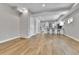 Spacious open-concept living area with hardwood floors and white trim at 1270 Winona Ct, Denver, CO 80204