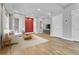 Bright living room showcasing hardwood floors, large windows, and a modern accent wall at 1270 Winona Ct, Denver, CO 80204