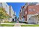 Contemporary townhouses with stone accents, colorful facades, and landscaped walkway at 1270 Winona Ct, Denver, CO 80204