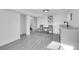 Spacious finished basement featuring wood-look flooring, neutral walls, and a wet bar at 4642 Everett Ct, Wheat Ridge, CO 80033