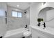Updated bathroom with tiled walls, shower-tub combo, and modern vanity at 4642 Everett Ct, Wheat Ridge, CO 80033