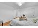 Bright bedroom featuring wood floors, white walls, and a bed with a decorative tray at 4642 Everett Ct, Wheat Ridge, CO 80033
