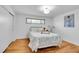 Serene bedroom featuring hardwood floors, a comfortable bed, and a minimalist aesthetic at 4642 Everett Ct, Wheat Ridge, CO 80033