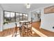 Sunlit dining area features hardwood floors, large windows, and views of the backyard at 4642 Everett Ct, Wheat Ridge, CO 80033