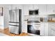 Stainless steel appliances and white shaker cabinets in the kitchen at 4642 Everett Ct, Wheat Ridge, CO 80033