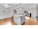 Open-concept kitchen features a spacious island with seating, hardwood floors, and modern pendant lighting at 4642 Everett Ct, Wheat Ridge, CO 80033