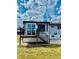Back of house featuring sunroom and deck with stairs to the grassy lawn at 4642 Everett Ct, Wheat Ridge, CO 80033