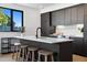 Modern kitchen boasts a large island with seating and sleek cabinetry at 1601 Park Ave # 216, Denver, CO 80218
