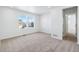 Bright bedroom features two sunny windows, neutral carpet, and a doorway leading to another room at 3324 N Catawba Way, Aurora, CO 80019