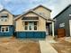 New construction home featuring light brown vertical siding, white trim, and black window awning at 3324 N Catawba Way, Aurora, CO 80019