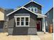 Charming two-story home with gray siding, brick foundation, and a vibrant red front door at 3324 N Catawba Way, Aurora, CO 80019
