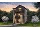 Charming new construction home with a three-story façade, multiple balconies, and stone accents at 8631 Hotchkiss St, Littleton, CO 80125