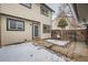 Small patio and fenced backyard with snow at 11919 E Yale Ave, Aurora, CO 80014