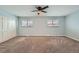 Well-lit bedroom featuring neutral walls and carpet at 11919 E Yale Ave, Aurora, CO 80014